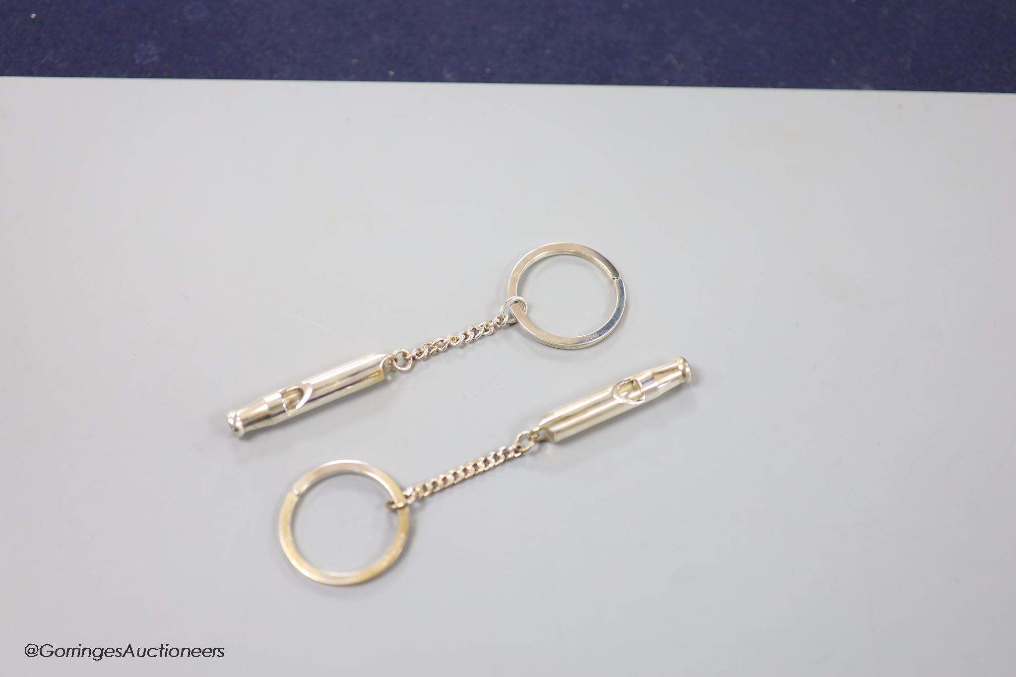 Two boxed modern silver Master of Craftmanship sterling 915 whistle key chains.